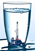 Image of drilling rig in a glass of water