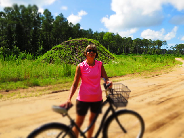 Photo - Debbie in front of hill of dirt