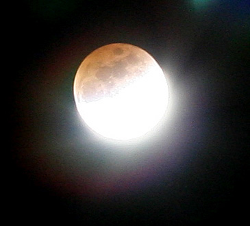 Photo of lunar eclipse with light artifacts