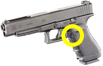 Photo of a Glock 34 showing magazine release button