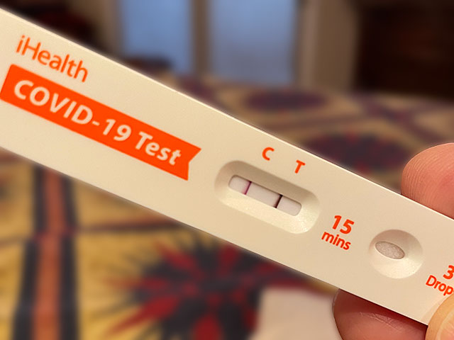 Photos: COVID test strip showing positive results