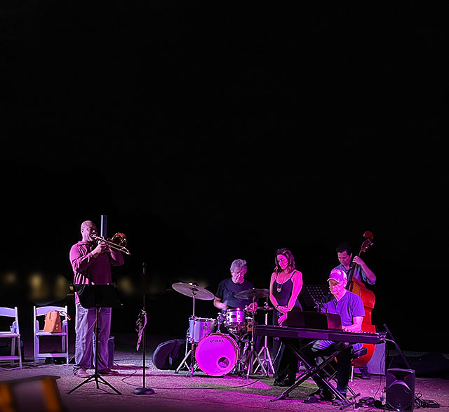 Color photo: Jazz quintet playing at night