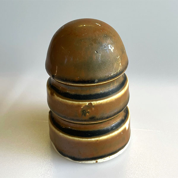 Photo - A brown-colored porcelain insulator