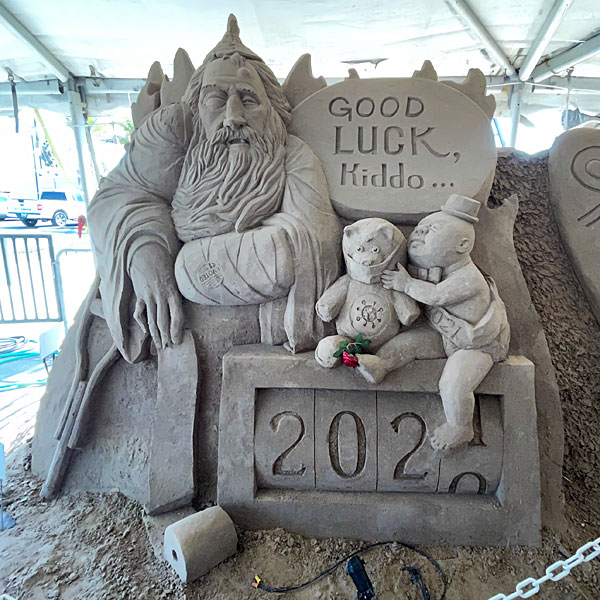 Photo of a sand sculpture depicting the transition from 2020 to 2021