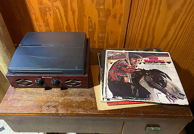 Photo: Small record player along with a Glen Campbell vinyl LP