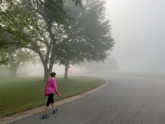 Photo: Debbie walking toward a dense fog bank