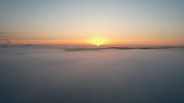 Photo: Sunrise as seen by a drone flying above the fog at about 400' altitude